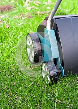 Scarifier on green grass. Work in the garden. scarifier