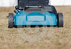 Scarifying lawn with scarifier, scarifies the lawn and removal of old grass