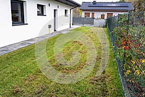 Scarifying the lawn before the winter season using an electric scarifier.