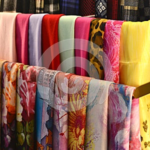 Scarves on racks in fashion store,close up photo