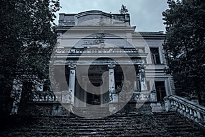 Scary abandoned manor in a dark forest. photo