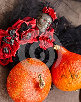 Scary background for Halloween from pumpkins and cobwebs, lace and roses.