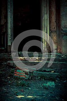 Scary background in horror style, an open door entrance to a dangerous staircase of an old house, stair steps to a