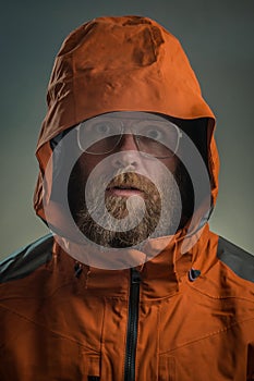 Scary bearded man in orange jacket