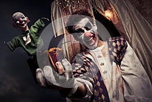 Scary clown holding a Jack-in-the-box toy photo