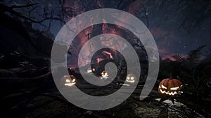 Scary dark mysterious forest with glowing pumpkins. Halloween horror concept. The Halloween Background is perfect for