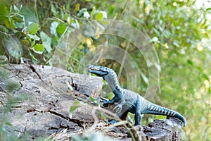 Scary dinosaur toy in the bushes, jurassic park concept, prehistoric animals in the modern world