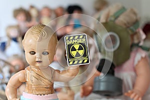 Scary doll showing radiation sign