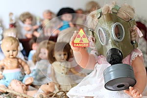 Scary doll showing radioactivity sign