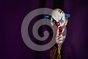 Scary evil clown asking for silence