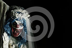 Scary evil clown in a bride dress