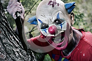 Scary evil clown with a knife