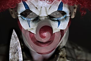 Scary evil clown with a knife