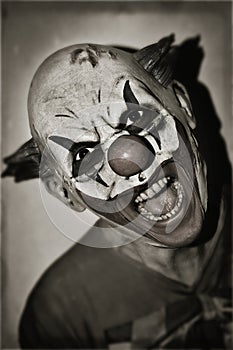 Scary evil clown in sepia toning