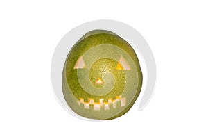 Scary face carved in pomelo fruit with candle inside isolated in white background