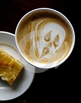 Scary face on frothy coffee