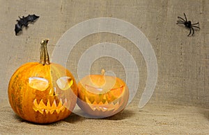 Scary glowing pumpkins faces. Scary Halloween pumpkins on a burlap background.