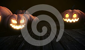 Scary halloween background with pumpkins face glowing on wood table in the dark night and copy space