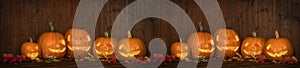 Scary Halloween celebration holiday party card background banner panorama - Many spooky carved glowing pumpkins, jack o lanterns