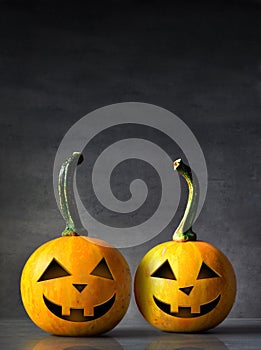 Scary Halloween pumpkins on a black background. Scary smiling faces trick or treat.