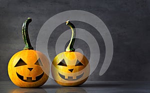 Scary Halloween pumpkins on a black background. Scary smiling faces trick or treat.