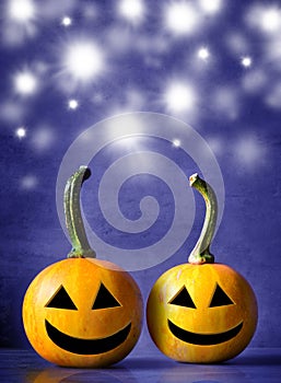 Scary Halloween pumpkins on a blue background. Scary smiling faces trick or treat.