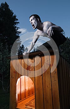 Scary man sitting on kennel