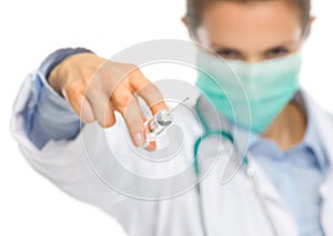 Scary medical doctor woman in mask using syringe