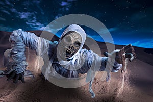 Scary mummy in a desert at night