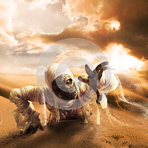 Scary mummy in a desert at sunset with copy space