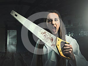 Scary portrait of an angry woman with a saw