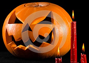 Scary pumpkin, jack lantern, pumpkin halloween, red candles on a black background, halloween theme, pumpkin killer