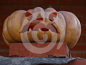 Scary pumpkins on a background of a brick wall