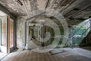 A scary room with a staircase in an abandoned building. Dirty and shabby walls. Stairs with steps.