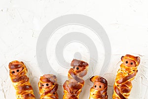 Scary sausage mummies in dough for kids party. Funny crazy Halloween food for children