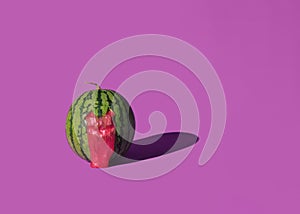 Scary slimy watermelon ghost face on pink background