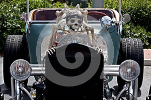 Scary souped up hotrod car with skeleton