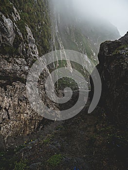 Scary steep hiking path stairs on steep mountain. hiking path sign on a stone, brienzer rothorn switzerland