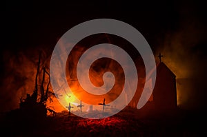 Scary view of zombies at cemetery dead tree, moon, church and spooky cloudy sky with fog, Horror Halloween concept