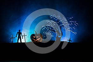 Scary view of zombies at cemetery dead tree, moon, church and spooky cloudy sky with fog, Horror Halloween concept with glowing