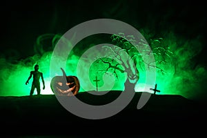 Scary view of zombies at cemetery dead tree, moon, church and spooky cloudy sky with fog, Horror Halloween concept with glowing