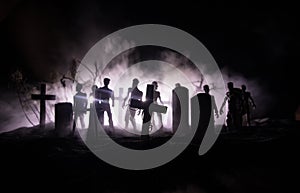 Scary view of zombies at cemetery dead tree, moon, church and spooky cloudy sky with fog, Horror Halloween concept with glowing