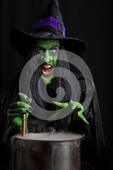 Scary witch stirring a cauldron