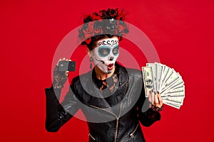 Scary young creepy lady calavera. wears artistic make-up for the feast of all the dead.Wears black leather jacket and lace gloves