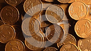 Scattered 20 euro cent coins, rotating money background