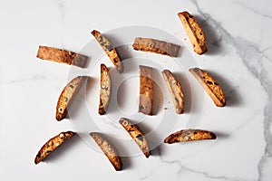 Scattered Almond and Cranberry Biscotti on Marble Surface, Aerial View with Elegant Shadows