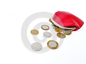Scattered Belarusian coins from a red leather purse on a white background.