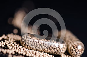 Scattered capsule. Pharmacy background on a black table. Tablets on a black background. Pills. Medicine and healthy.