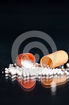 Scattered capsule. Pharmacy background on a black table. Tablets on a black background. Pills. Medicine and healthy.