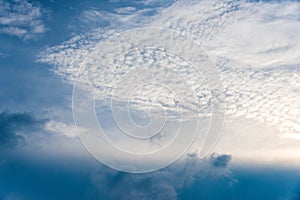 Scattered cloud clusters in a blue sky, blue sky background with white clouds